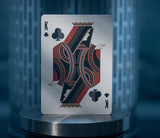 King of Clubs playing card on a reflective surface with a blurred background