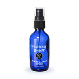 Blue spray bottle labeled 'Cranberry Hollow' on a white background