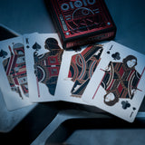 Playing cards with intricate designs on a dark surface