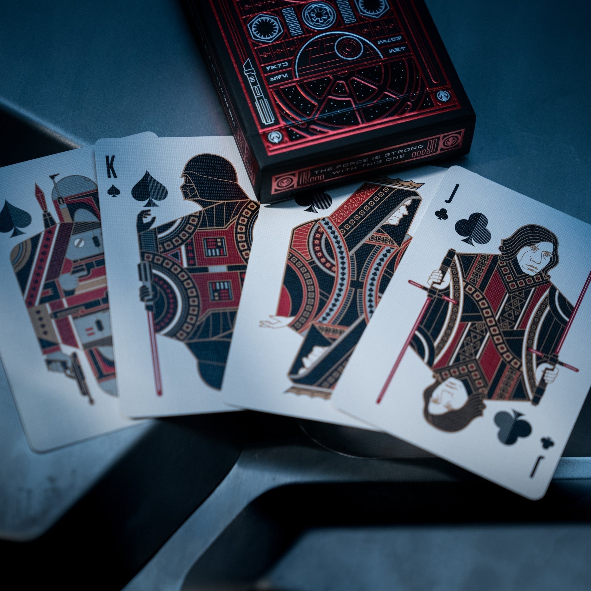 Playing cards with intricate designs on a dark surface
