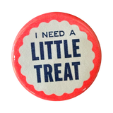 Blue lettering on a pink and white button