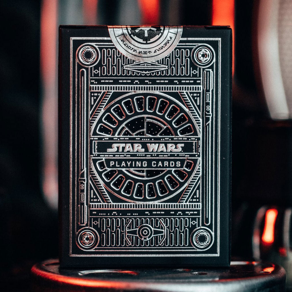 A pack of Star Wars playing cards with a black box with silver foil detail.